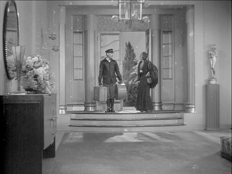 (above) His home. The use of steps dropping from the front door entrance into the foyer is a common architectural feature used in films of the 1930s and 40s.