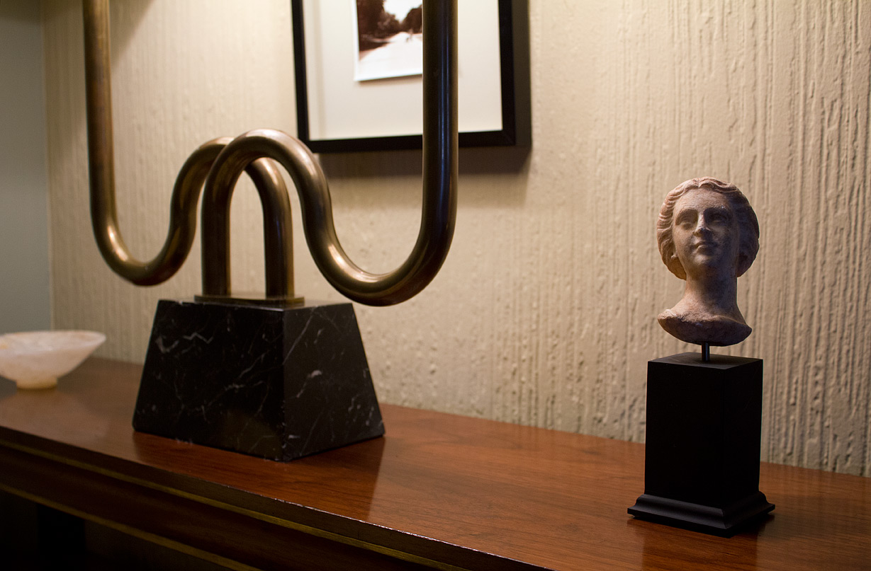 A newly acquired classical artifact now resides on the couch’s end table.