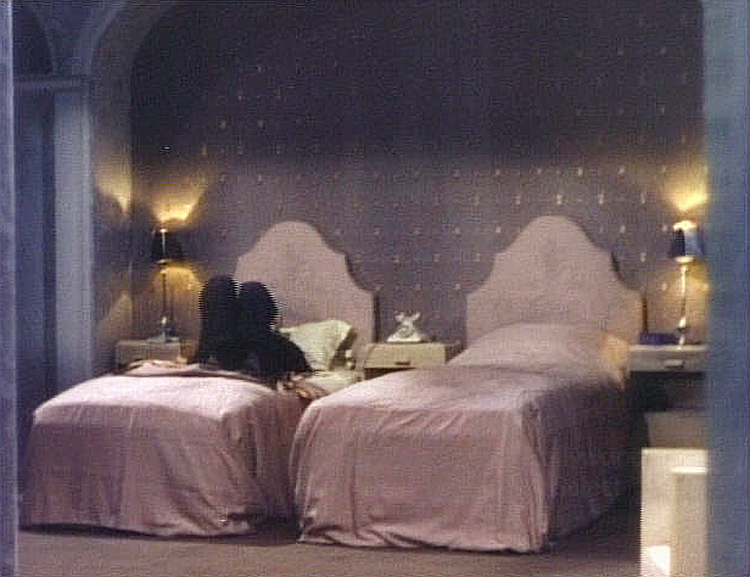 (above) This is the only frame that captured both beds with some of the architectural detailing. Were hotel rooms back then really this elaborate? I want that phone.