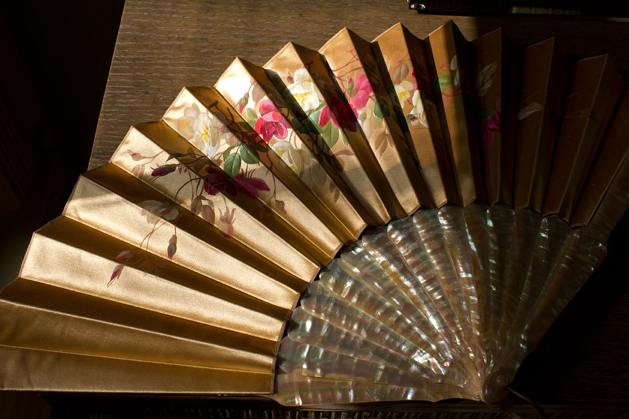 (above) This circa 1900 fan is made of hand painted silk with natural mother of pearl guards and sticks.