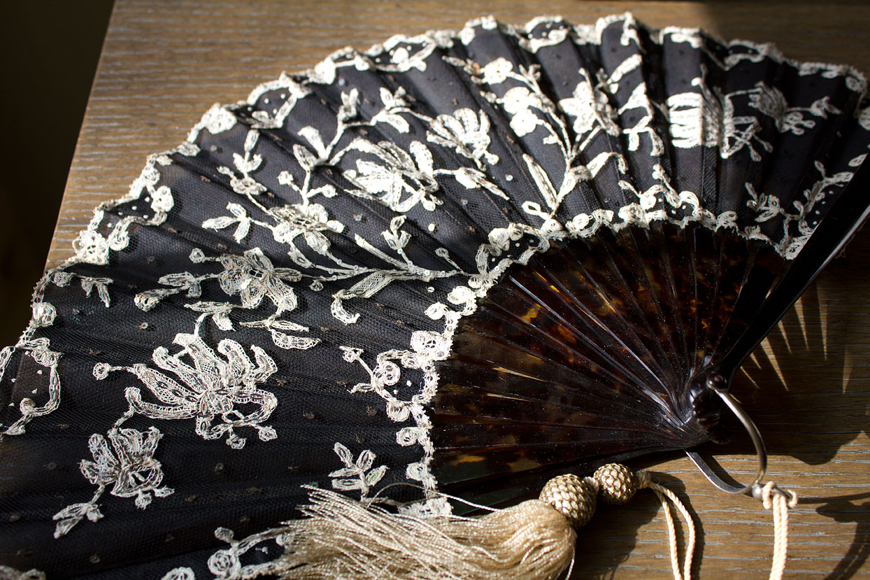 (above) Art Nouveau (circa 1880-1890) opera fan with black tulle fine net leaf and applied lace embellished with silver sequins and spangles. The sticks are undetermined natural or faux marbled shell.