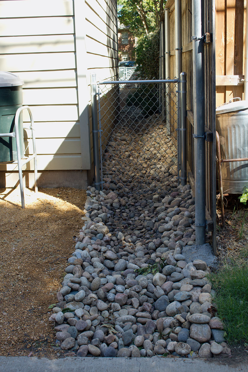 The field of contention is the above swale which helps drain the backyard into the alley after heavy rain storms.